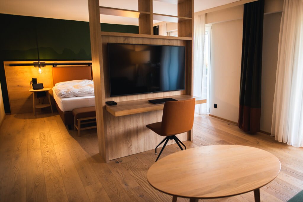 "Modern bedroom interior with neatly arranged wooden bed, side tables, and cozy decor elements"