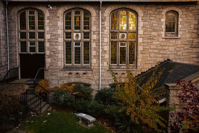 Landscaped front area with manicured lawn, pathways, and greenery highlighting classic landscaping ideas for the front of the house