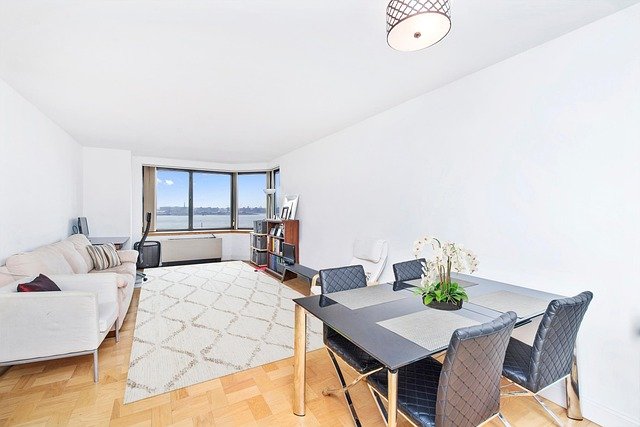 Modern open-plan living dining room showing smart decorating ideas for living dining room combinations with cohesive furniture and lighting.