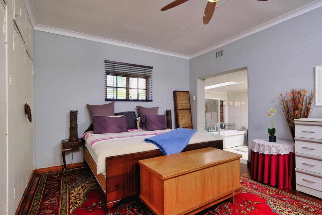 "Minimalist bedroom interior with modern bed, bedside furniture, and soft ambient lighting