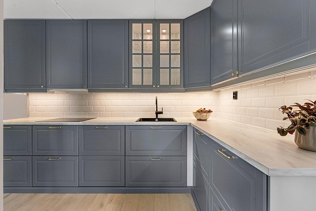 Vintage kitchen interior featuring classic cabinetry, soft neutral tones, and traditional decorative accents.