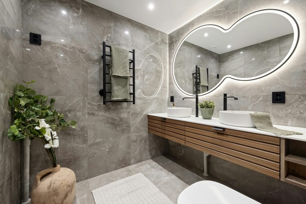 Modern bathroom decoration with floating vanity, round mirror, warm lighting, and minimalist decor accents.