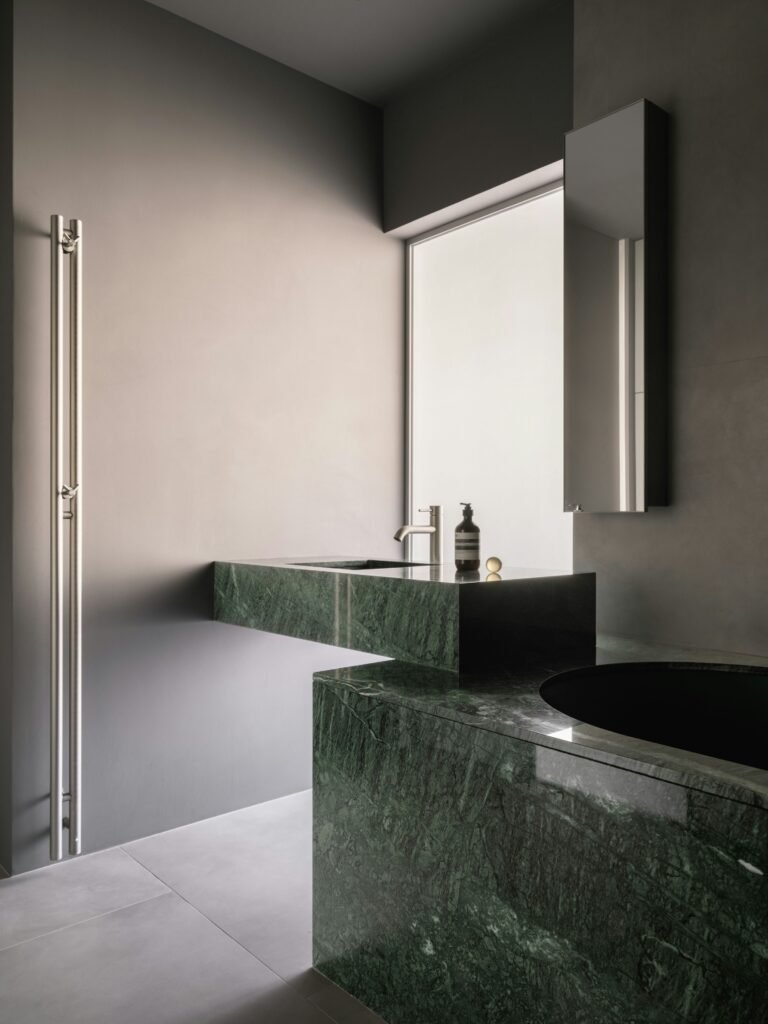 Contemporary bathroom decorations with glass shower enclosure, modern vanity, wall-mounted mirror, and minimalist decor accents.