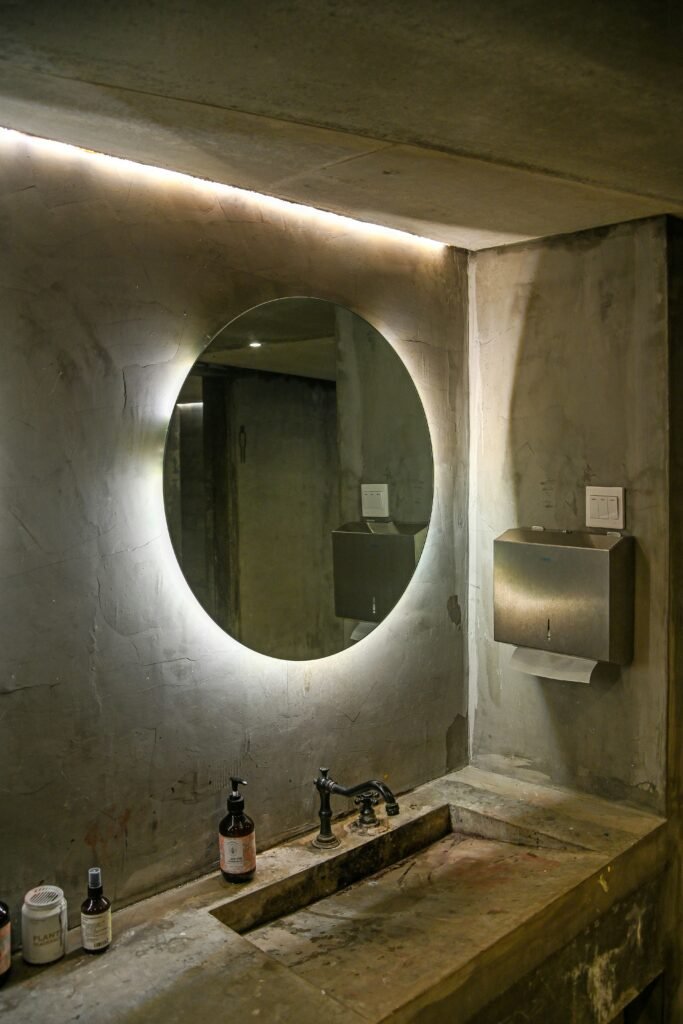 Modern bathroom interior featuring sleek fixtures, minimalist vanity, and soft ambient lighting.
