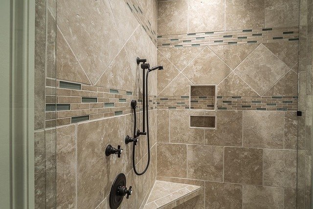  "Modern shower with glass enclosure, tiled walls, and sleek fixtures