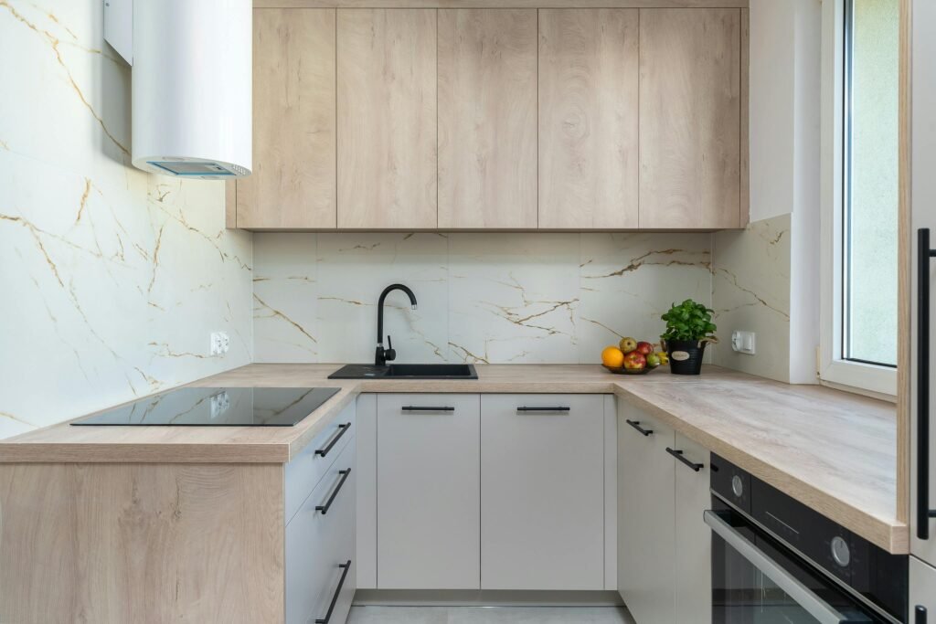 Spacious modern kitchen layout with extended island seating, minimalist cabinetry, and open-plan design reflecting current kitchen layout trends.
