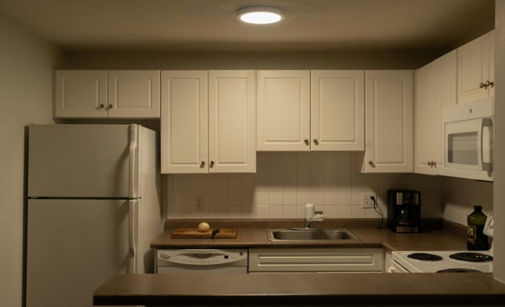 Contemporary galley kitchen layout with streamlined cabinetry, modern lighting, and efficient space planning reflecting current kitchen layout trends.