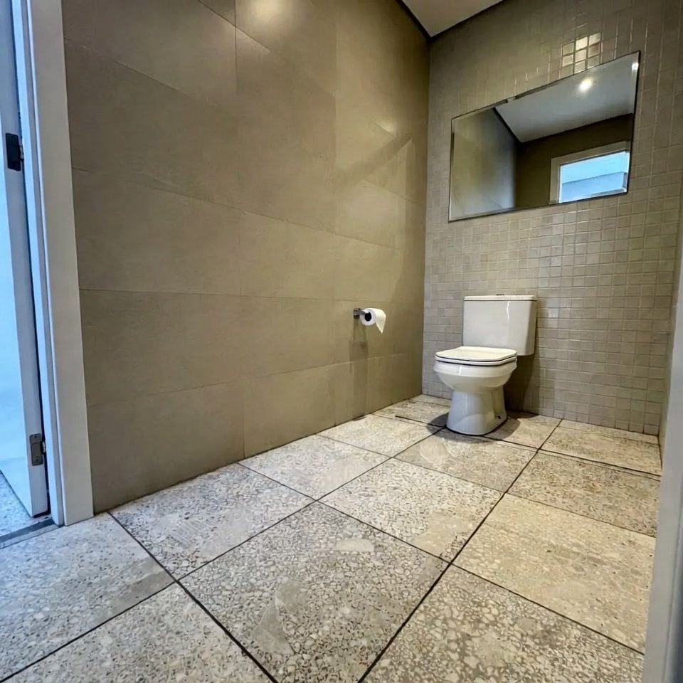 Bathroom with textured floor tiles designed to add grip and subtle surface detail.