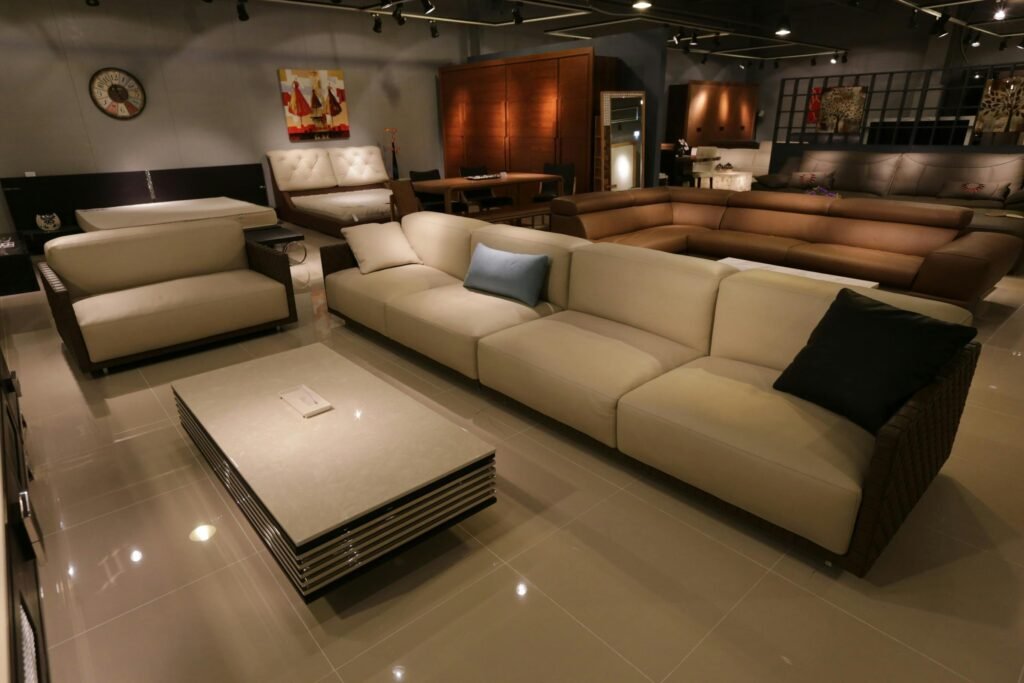 Modern living room illuminated with layered lighting including ceiling, floor, and accent lights