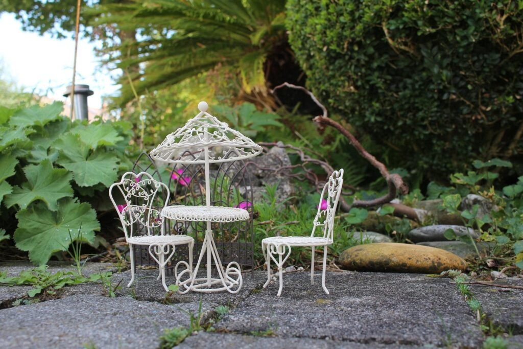 Mini garden arrangement with small potted plants, decorative stones, and compact greenery