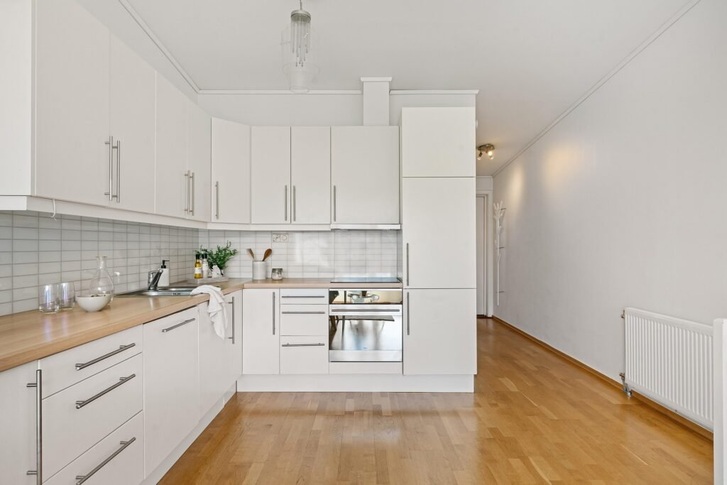 Bright modern kitchen with sleek finishes and smart storage, highlighting practical kitchen cabinets ideas for better organization
