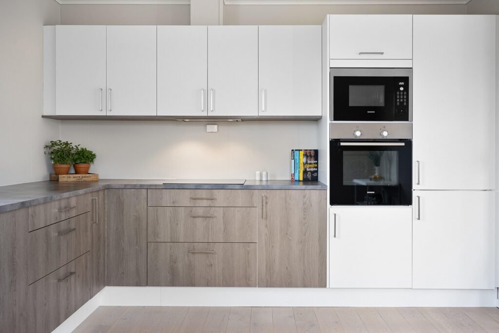 Modern kitchen interior featuring stylish storage solutions and sleek finishes, showcasing practical kitchen cabinets ideas