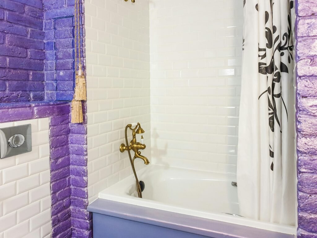 Modern bathroom with bold shower curtain design, clean tiles, and sleek fixtures