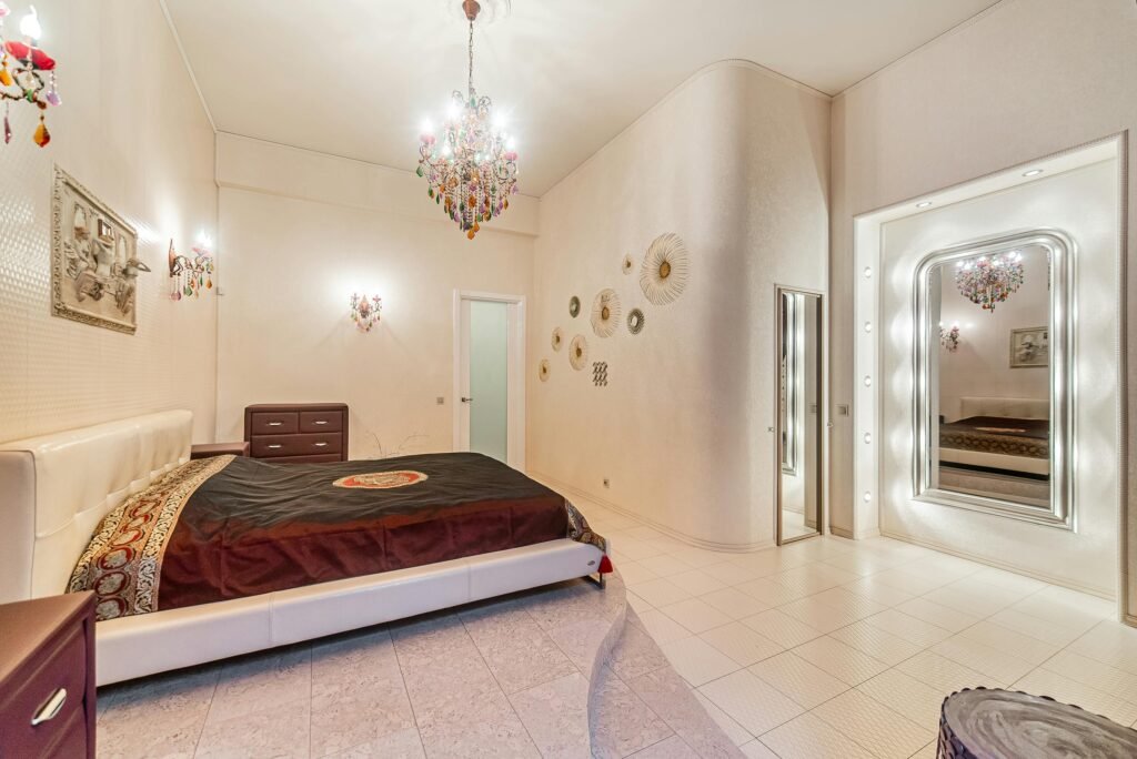 Modern bedroom with textured wall art for bedroom above the bed, neutral palette and soft lighting