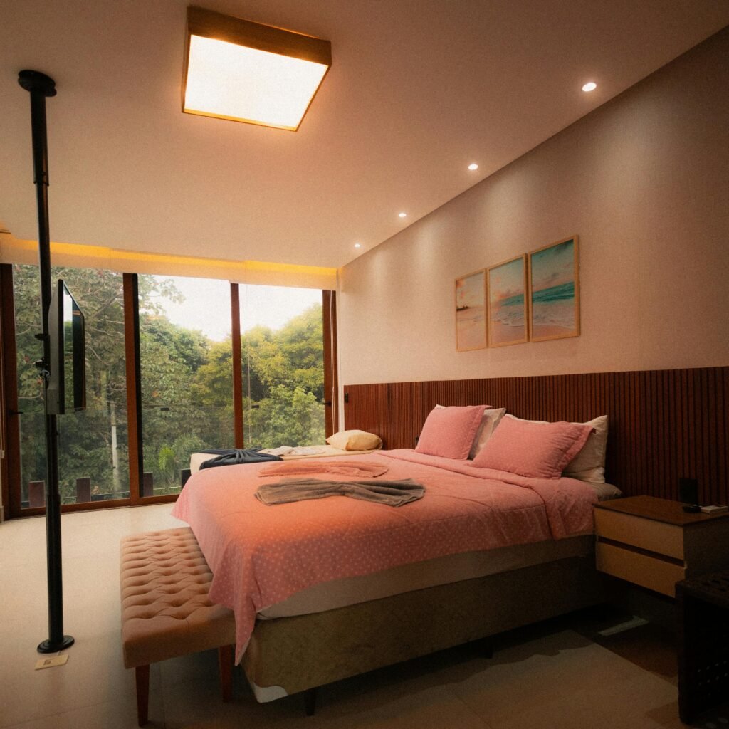 Modern luxury bedroom with warm lighting, plush bedding, and elegant decor
