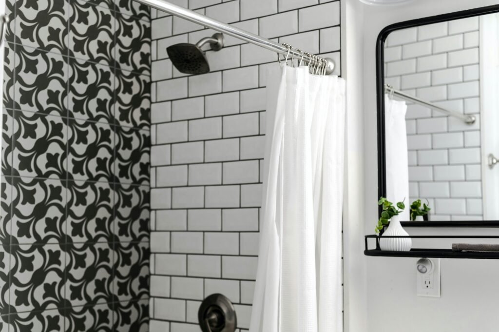 Modern bathroom with decorative shower curtain, soft lighting, and stylish interior details
