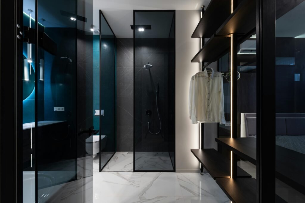Elegant bathroom with glass door for shower featuring frameless panels and modern tile finish