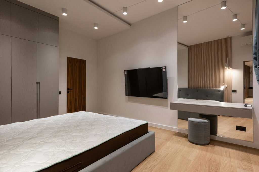 Contemporary bedroom vanity with sleek mirror, storage drawers, and soft lighting in a modern interior