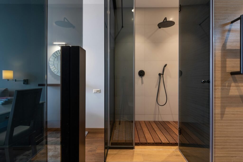 Contemporary bathroom with glass door for shower featuring frameless design and neutral tile walls