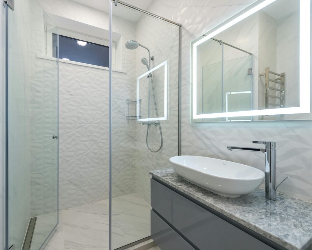 Contemporary bathroom with glass door for shower featuring frameless panels and modern interior