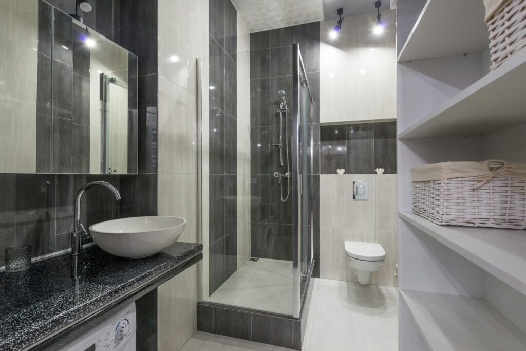 Stylish bathroom with glass door for shower featuring frameless design and sleek tile walls