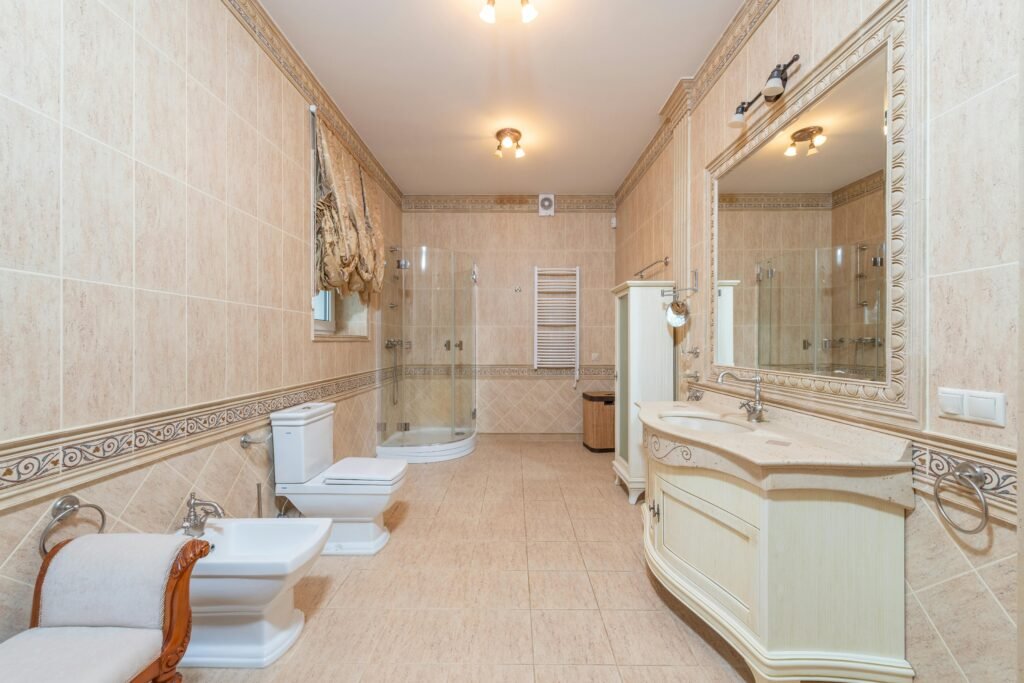 Modern bathroom with patterned shower curtain, tiled walls, and sleek fixtures