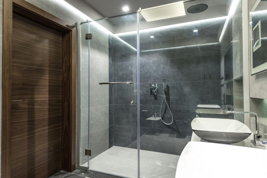Modern bathroom featuring a sleek glass door for shower with clean lines and minimal hardware