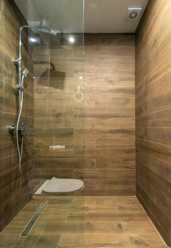 Modern bathroom with glass door for shower featuring sleek frameless panels and clean tile design