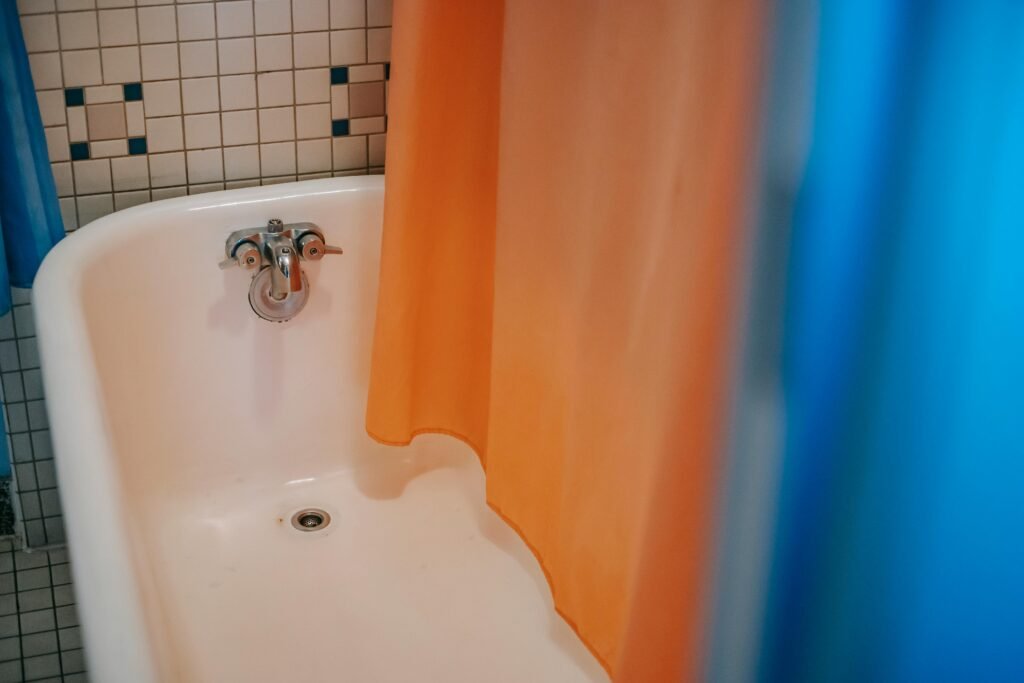 Bright bathroom interior with soft fabric shower curtain, natural light, and clean decor