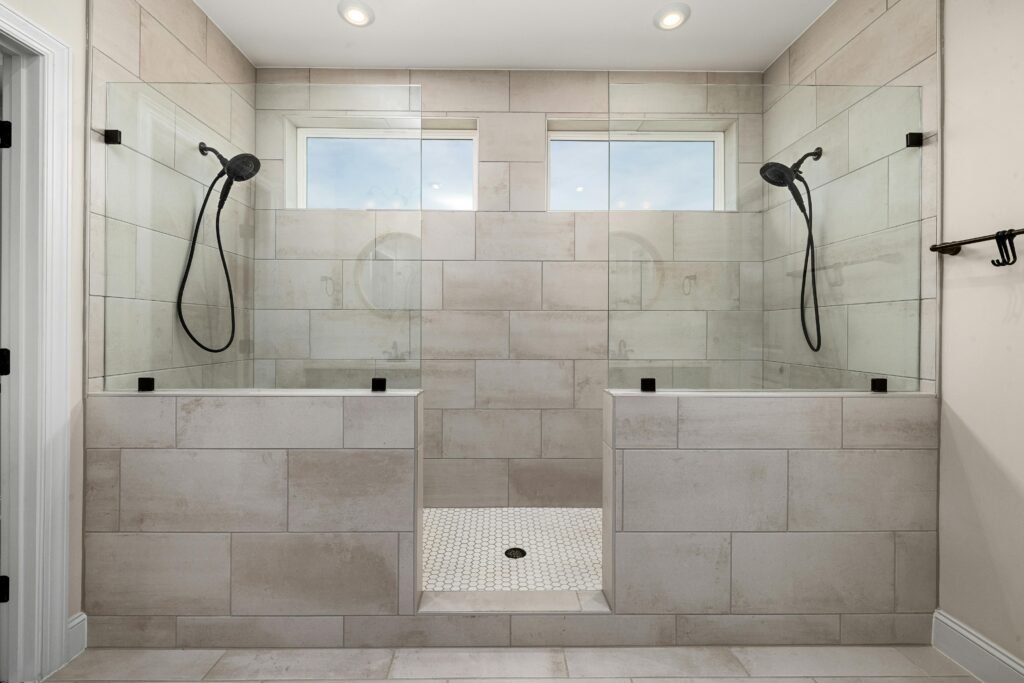 Contemporary bathroom with a sliding glass door for shower, soft lighting, and clean tile finish