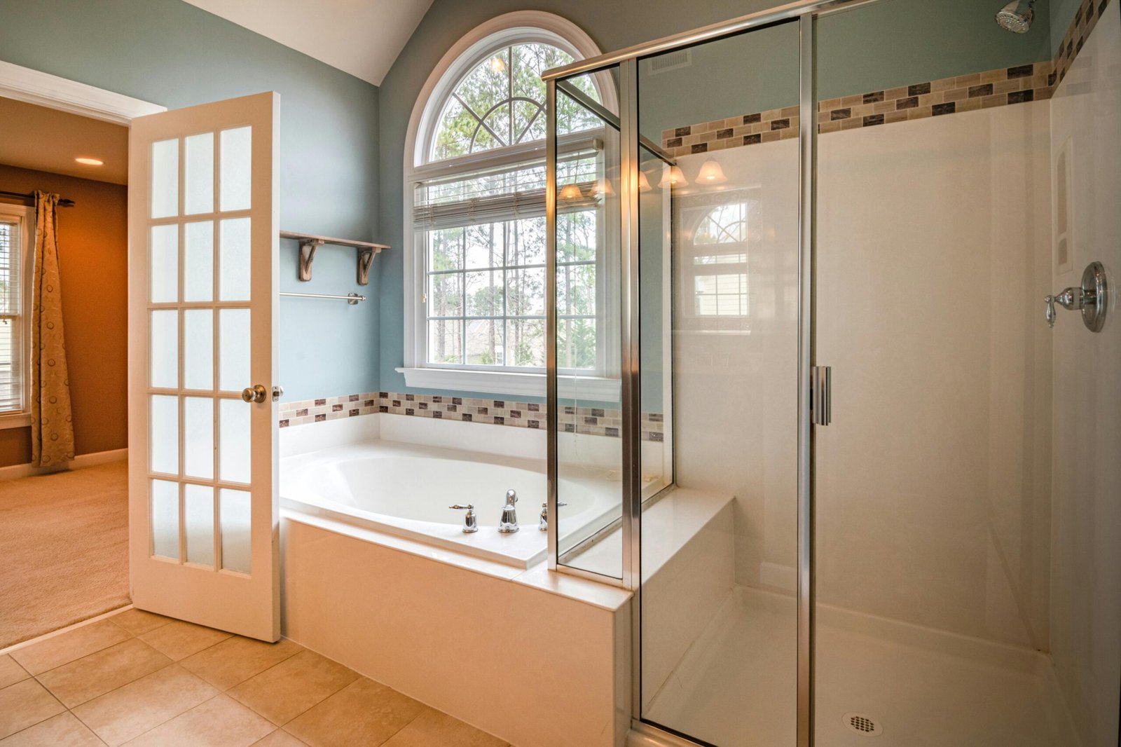 Modern bathroom with a glass door for shower featuring a clean frameless design and bright interior