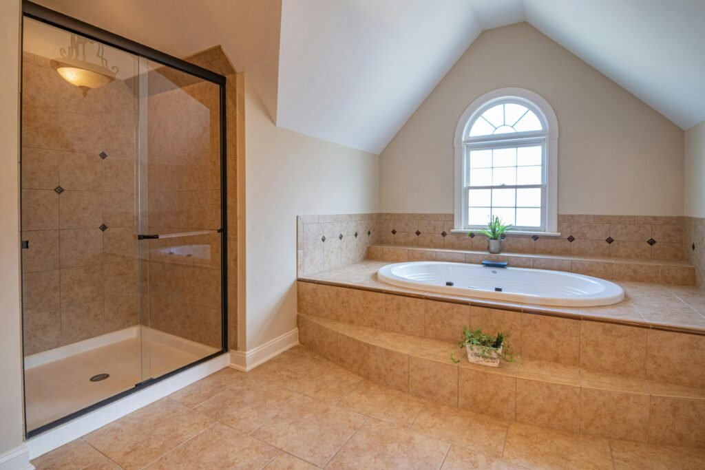 Modern bathroom with glass door for shower featuring clear frameless enclosure and bright interior