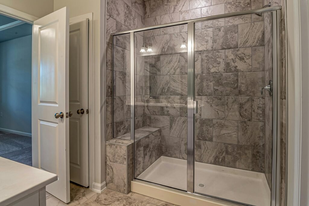 Contemporary bathroom with glass door for shower featuring clear panels and sleek modern fixtures