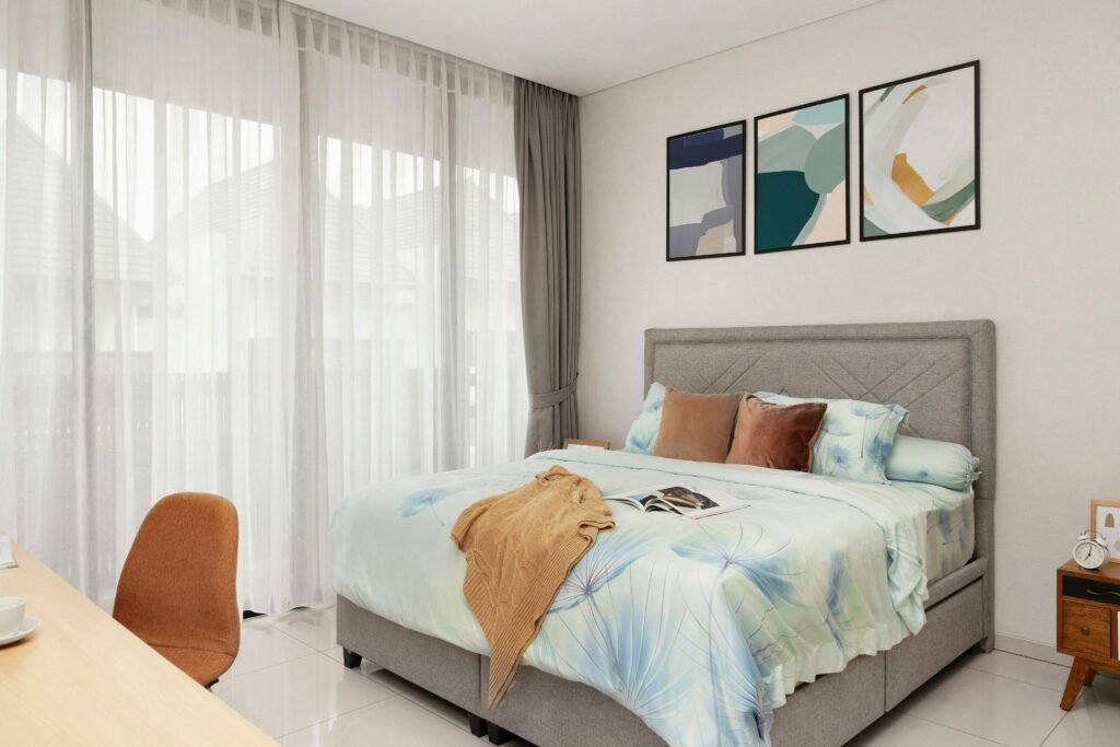 Dark modern bedroom with statement wall art for bedroom above the bed, moody tones and soft ambient lighting