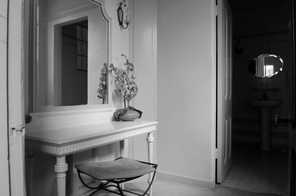 Modern vanity setup with mirror, lighting, and sleek bedroom cabinet design