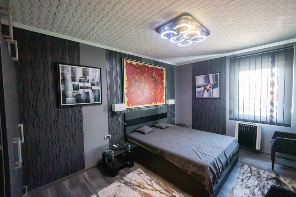 Cozy modern bedroom with framed wall art for bedroom above the bed, soft bedding, and warm natural light