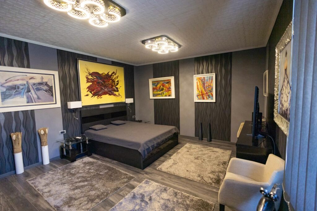 Modern cozy bedroom with framed wall art for bedroom above the bed, soft textures and warm lighting