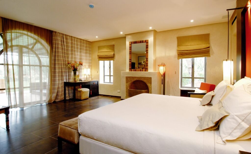 Modern bedroom vanity with mirror, soft lighting, and neatly arranged essentials