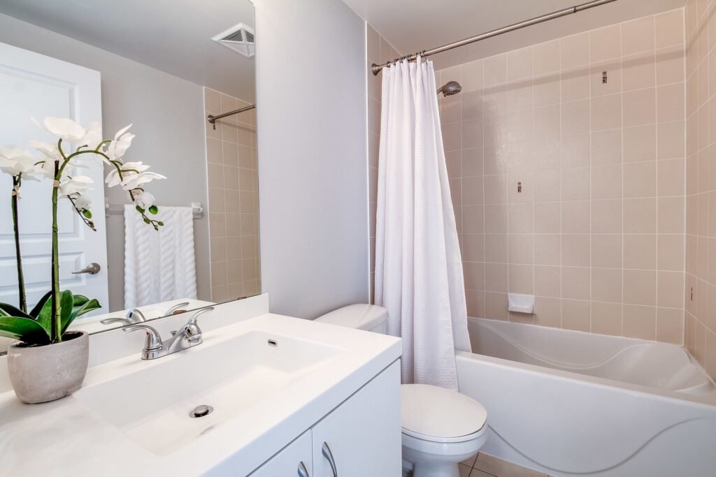 Modern condo bathroom with a stylish shower curtain and clean interior design