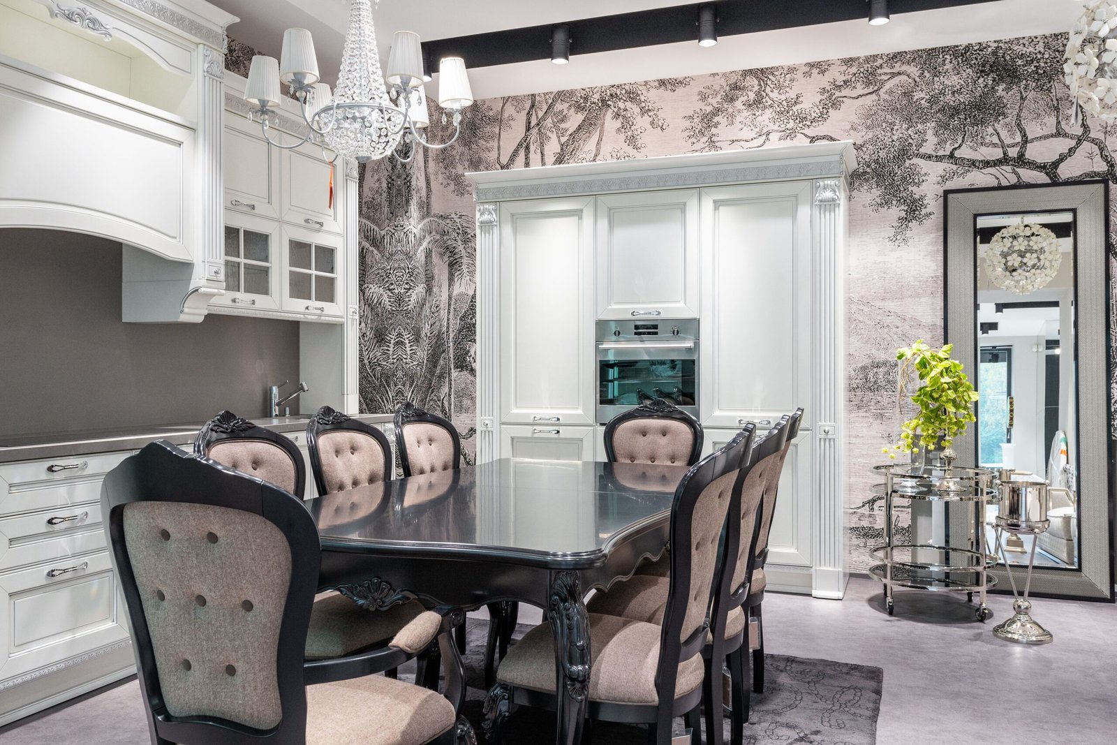 Modern dining room with a sleek dining table, upholstered chairs, pendant lighting, and contemporary decor.
