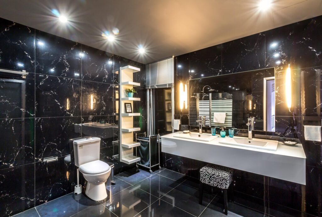Modern bathroom ideas featuring layered lighting, a floating vanity, illuminated mirrors, recessed ceiling lights, and a luxurious contemporary bathroom design.