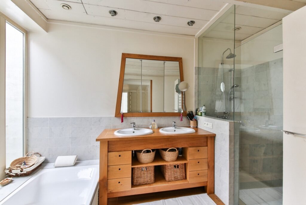 Modern bathroom ideas featuring natural wood materials, a floating wooden vanity, warm textures, elegant lighting, and a luxurious contemporary bathroom design.