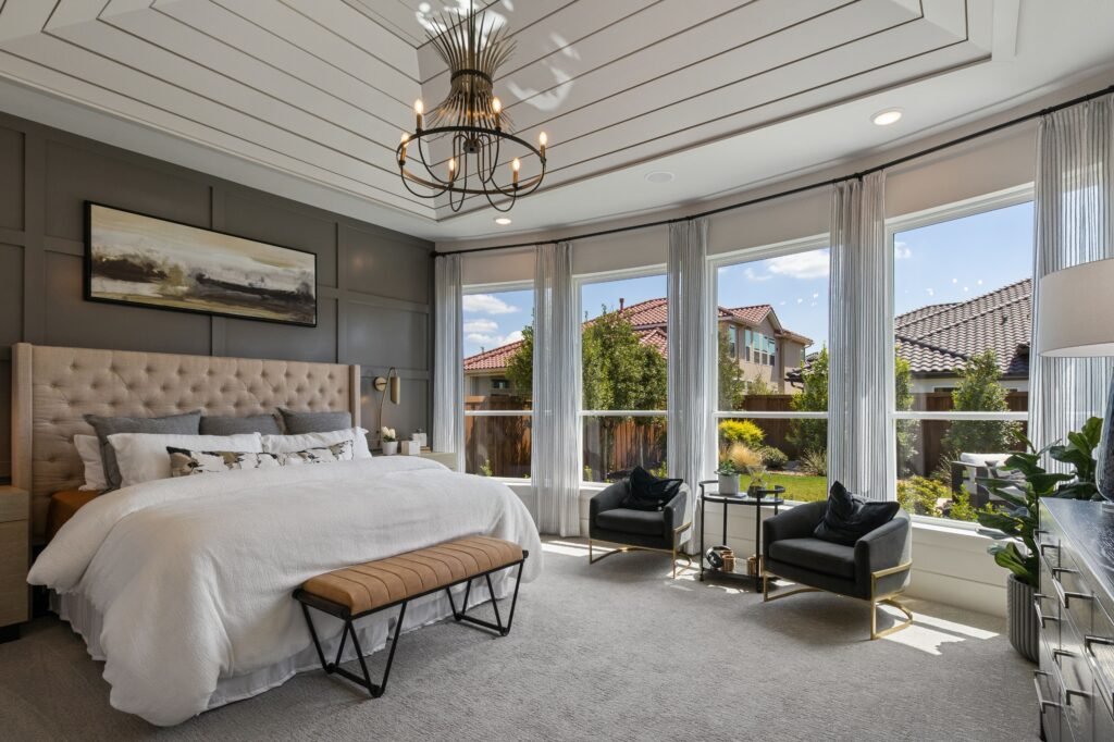 Master bedroom design ideas featuring a comfortable reading chair, stylish decor, soft lighting, and a relaxing bedroom retreat.