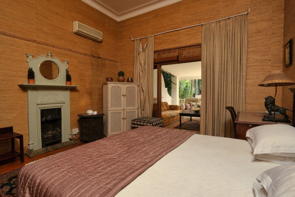 Modern master bedroom featuring a stylish fireplace feature wall, elegant furnishings, soft lighting, and contemporary decor for a luxurious atmosphere.