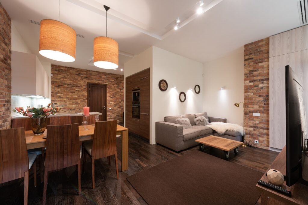 warm and cozy Living room featuring three layered textures with a soft rug, cozy throw blankets, and textured cushions for added warmth and depth