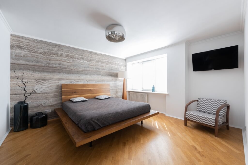 Modern master bedroom with floating furniture, featuring wall-mounted nightstands, a floating bed frame, clean lines, and contemporary décor.