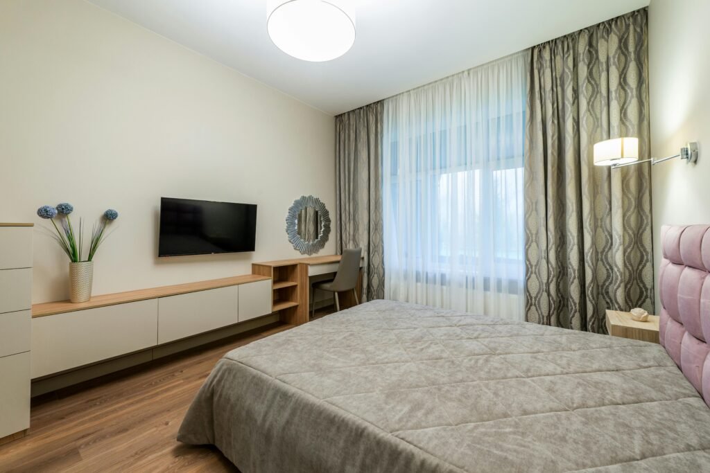 Affordable house in the USA featuring bedroom decorating ideas with multiple resources such as layered lighting, storage solutions, decor accents, and functional furnishings.