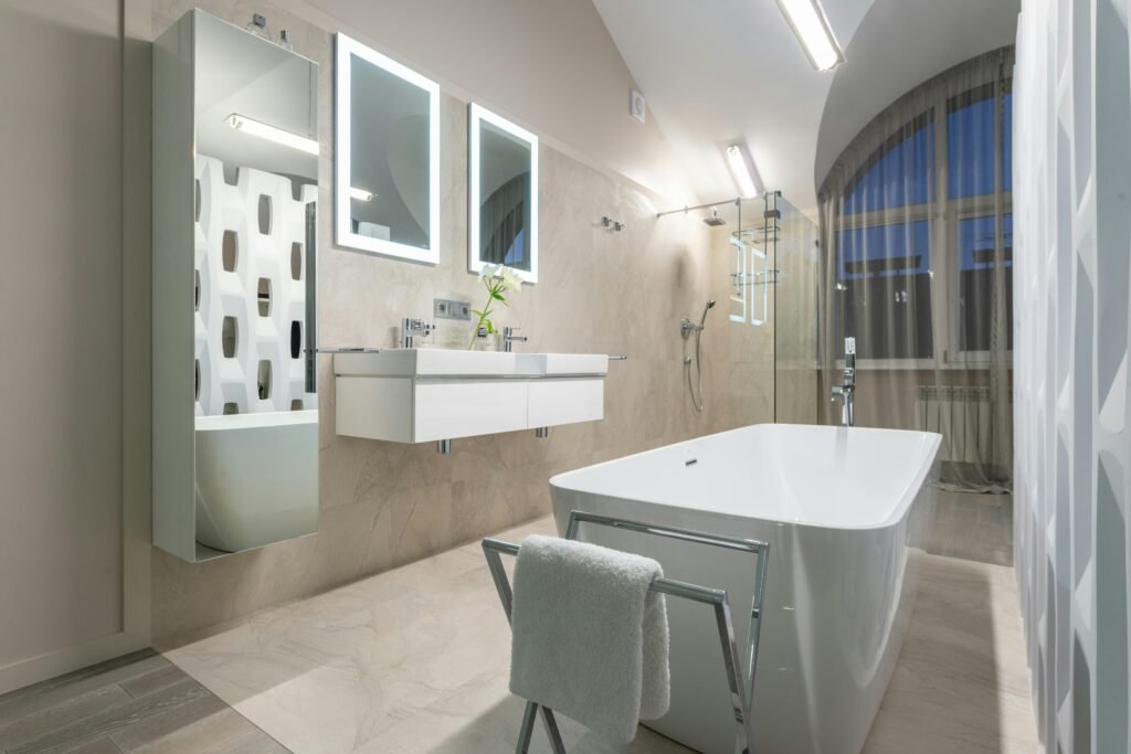 Modern bathroom featuring a freestanding bathtub as the focal point, surrounded by elegant finishes and natural light.