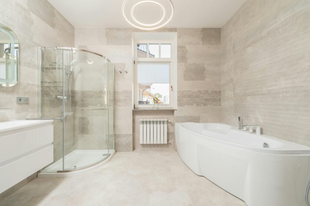 Modern bathroom with a statement ceiling featuring wood paneling, decorative lighting, and architectural details that enhance the space.