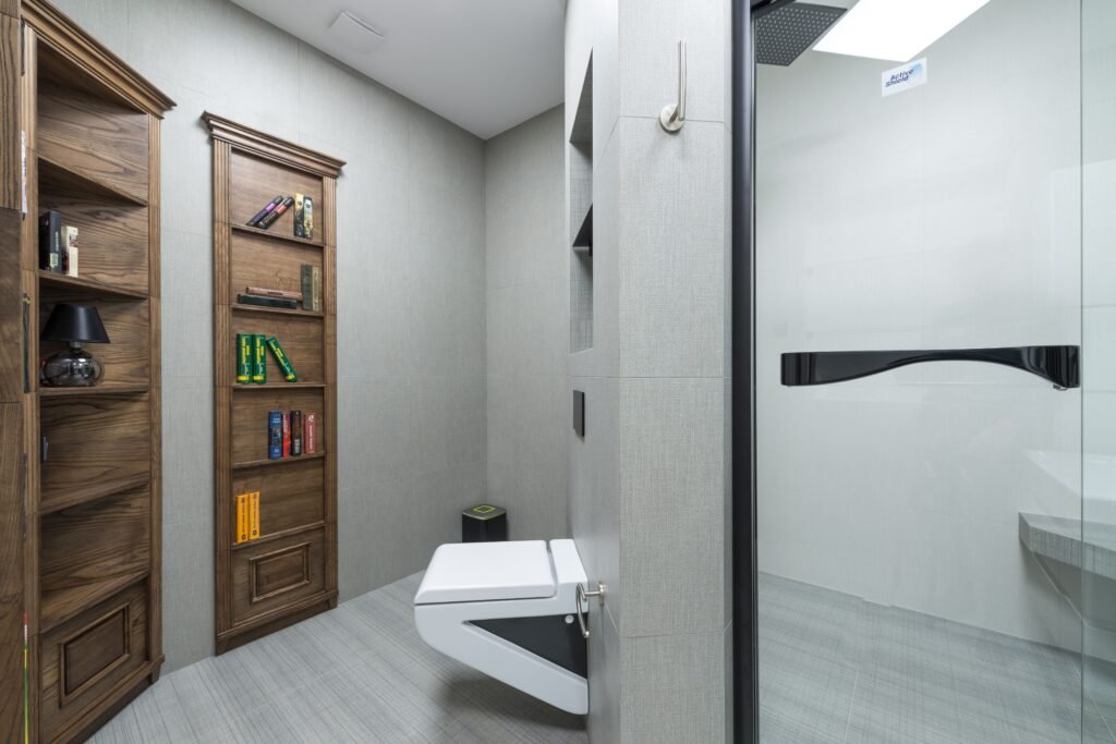 Small modern bathroom with vertical storage shelves, wall-mounted cabinets, and space-saving organization solutions.
